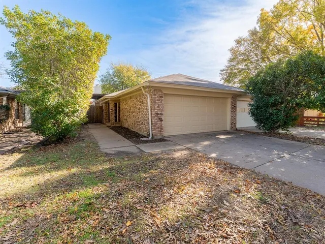 a view of a house with a yard and garage