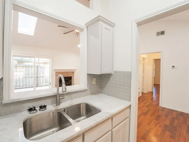 a kitchen with a sink cabinets and window