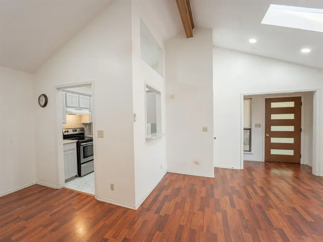 wooden floor in an empty room with a window