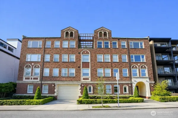 a front view of a residential apartment building with a yard