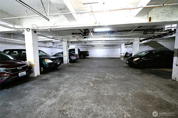 a view of parking garage with cars