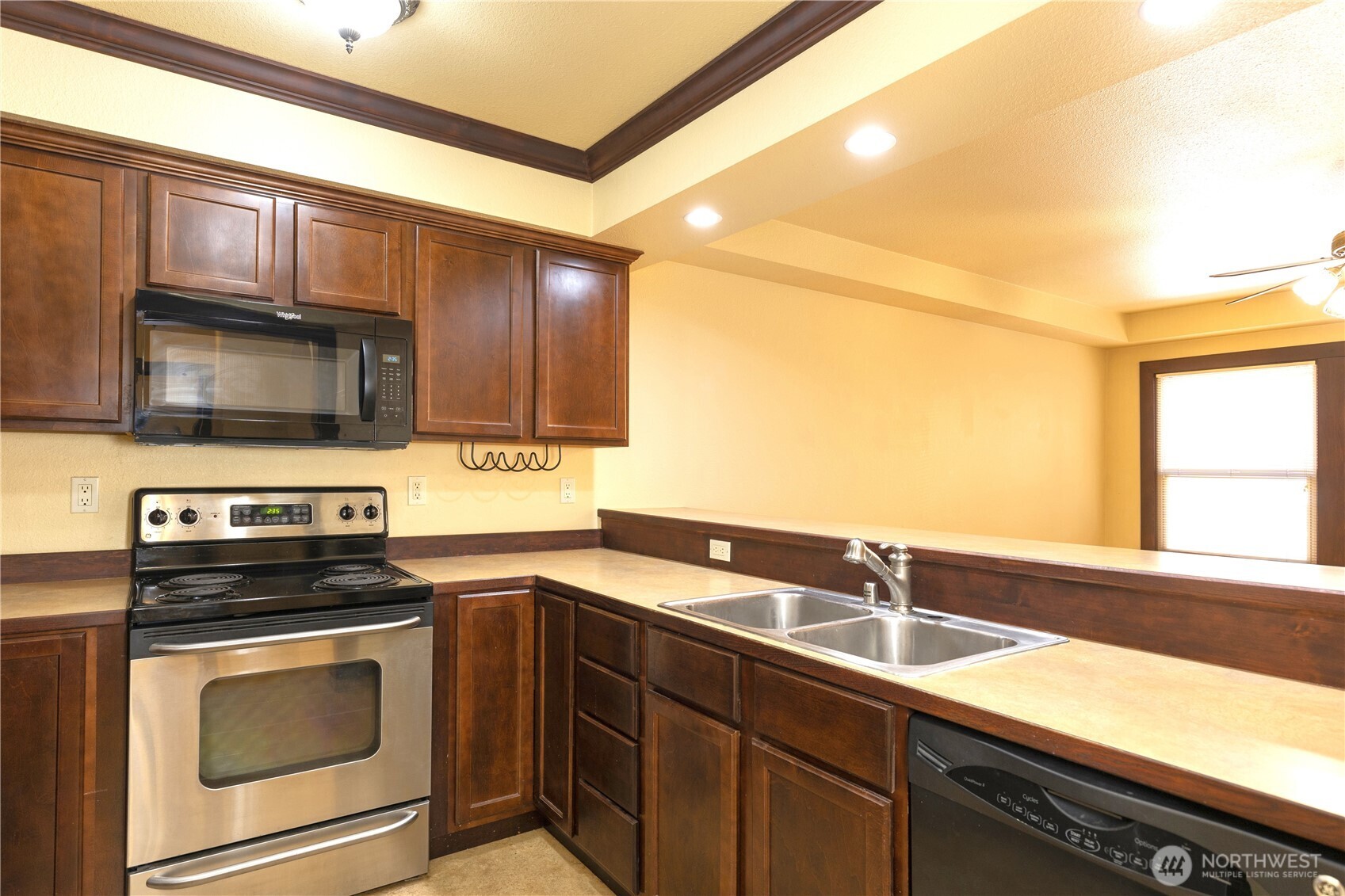 16 Valley Street Seattle, WA 98109 - Photo 19 of 40 a kitchen with stainless steel appliances a stove sink and cabinets