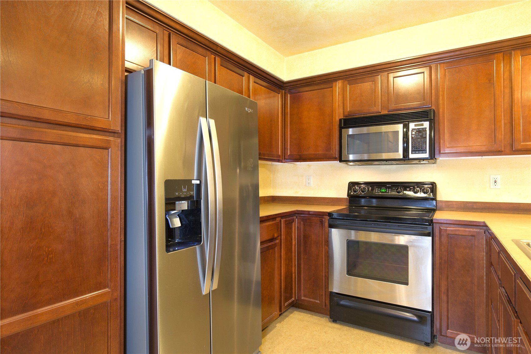 16 Valley Street Seattle, WA 98109 - Photo 24 of 40 a kitchen with a refrigerator stove and microwave