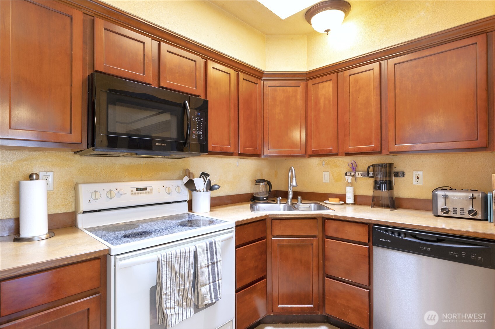 16 Valley Street Seattle, WA 98109 - Photo 27 of 40 a kitchen with stainless steel appliances granite countertop a sink stove and microwave