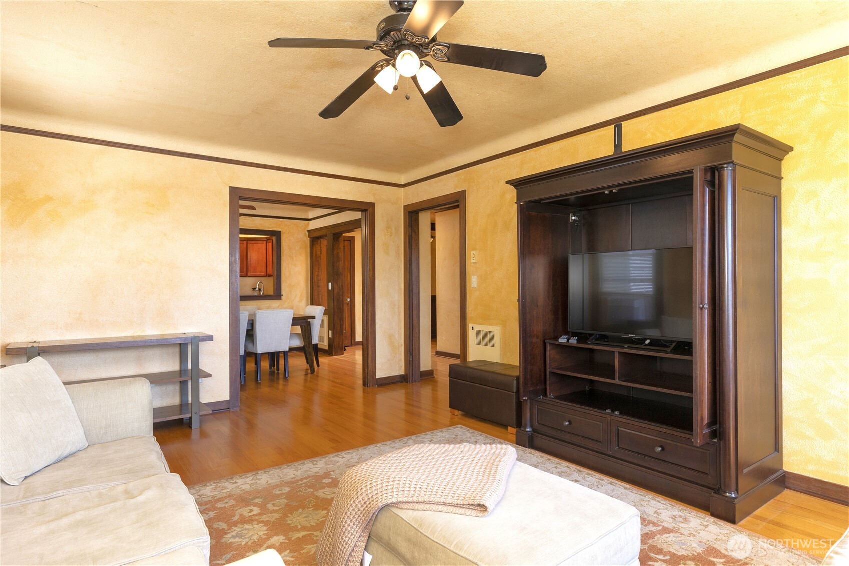 16 Valley Street Seattle, WA 98109 - Photo 31 of 40 a living room with couches a dining table and chairs with wooden floor
