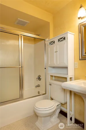 view of a hallway with wooden floor and a mirror