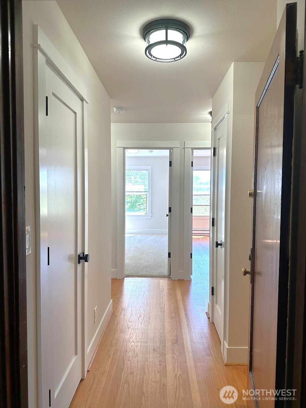 16 Valley Street Seattle, WA 98109 - Photo 36 of 40 view of a hallway with wooden floor and a mirror