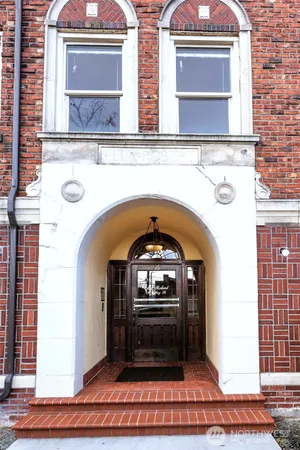 a living room with a fireplace and a wooden floor