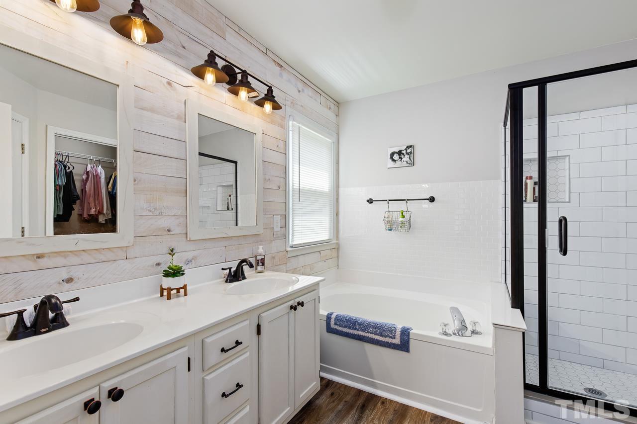5201 Sutter Way Raleigh, NC 27613 - Photo 17 of 29 New flooring, shiplap, and shower tiles make this bathroom a showpiece!