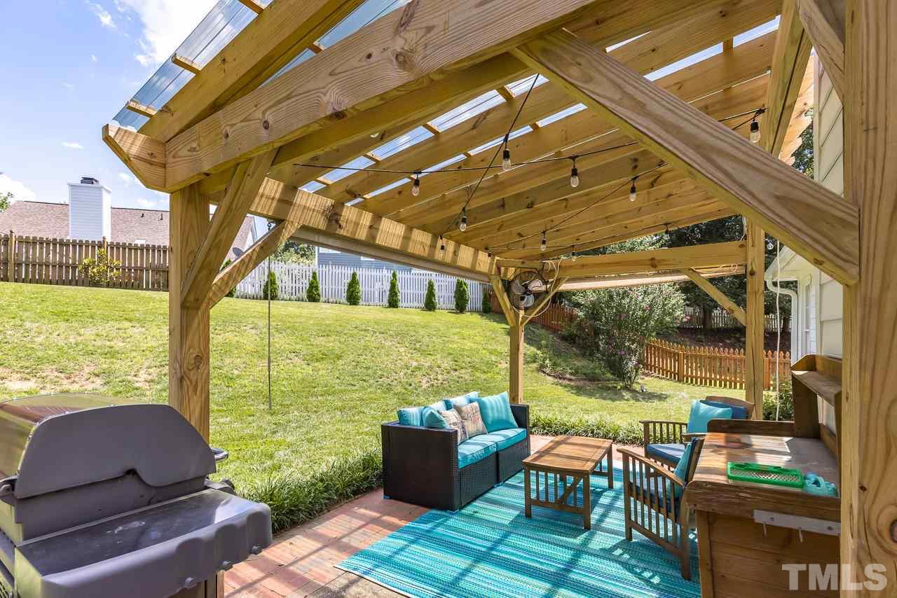 5201 Sutter Way Raleigh, NC 27613 - Photo 24 of 29 The lovely backyard is fully fenced and has a pergola for entertaining.