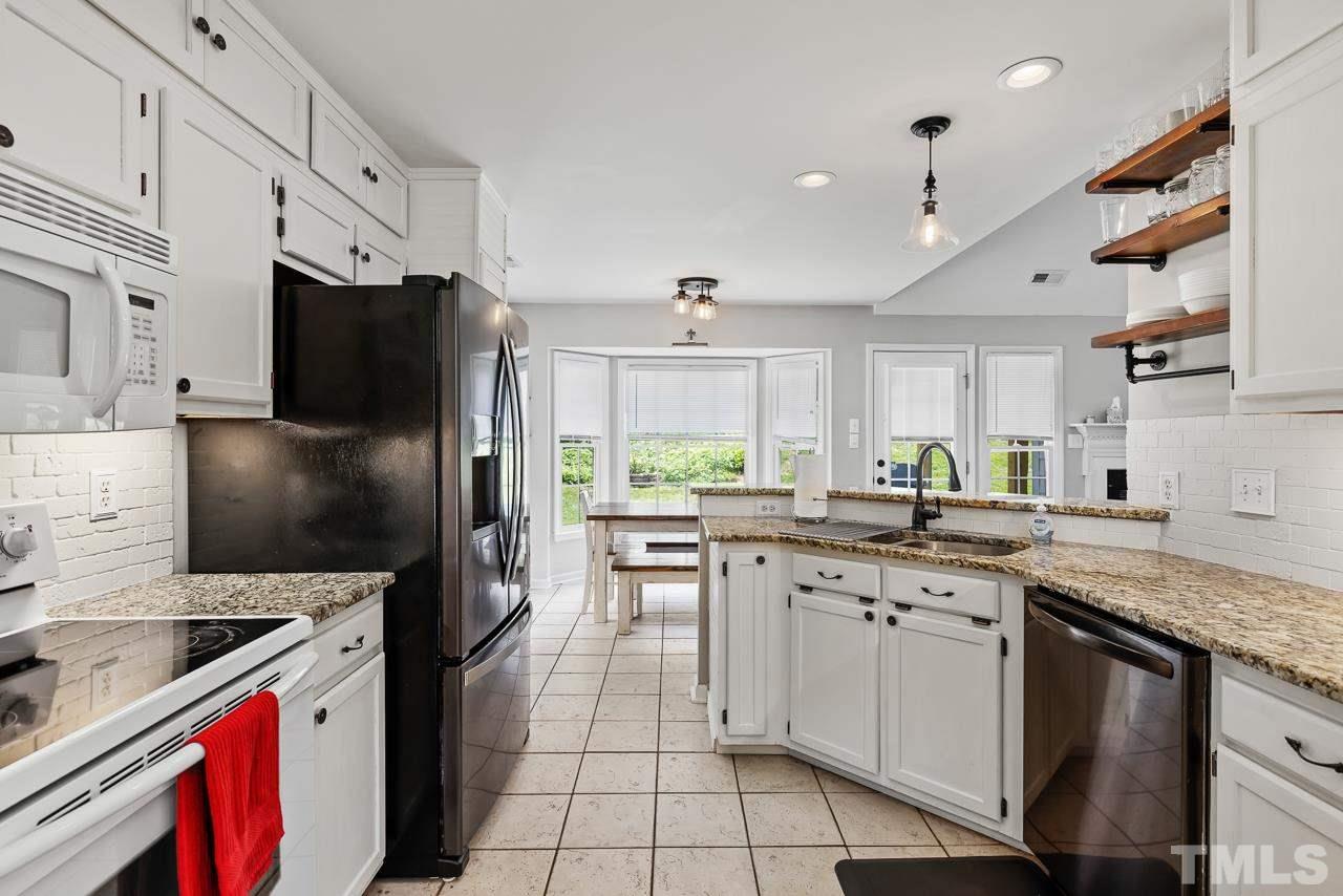 5201 Sutter Way Raleigh, NC 27613 - Photo 8 of 29 Granite counters and upgraded shelving.