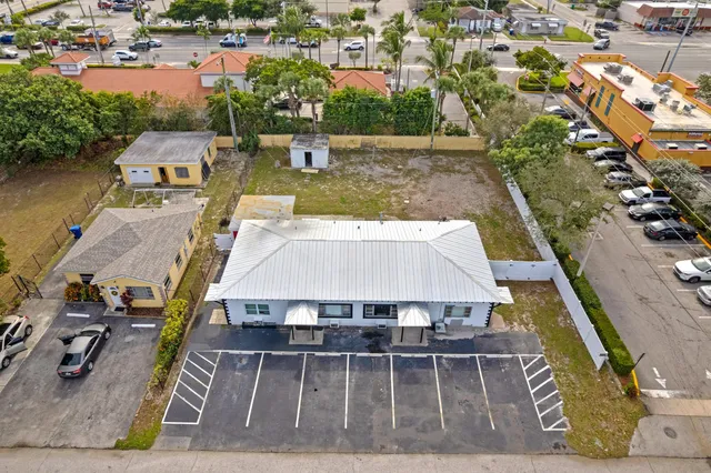 an aerial view of a house with swimming pool and outdoor seating