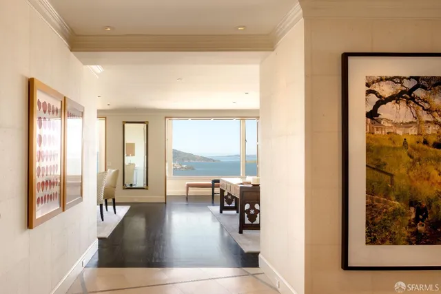 a living room with furniture and floor to ceiling windows