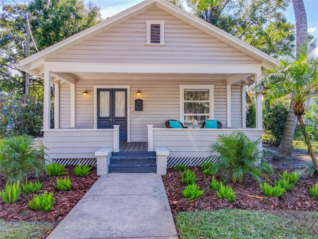 1406 East Ridgewood Street Orlando, FL 32803 - Photo 1 of 1 a front view of a house with a yard and potted plants