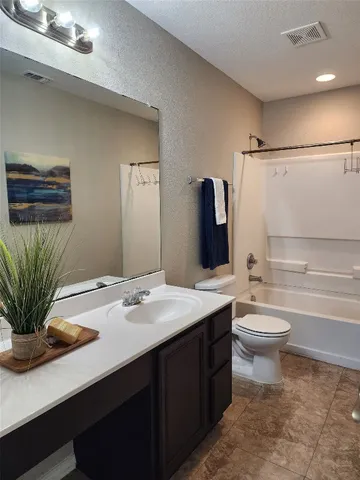 a bathroom with a sink a toilet and tub