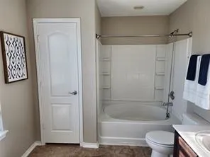 a bathroom with a bathtub a toilet and a shower