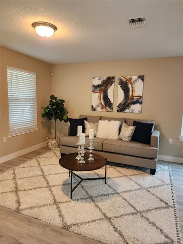 a living room with furniture and a window