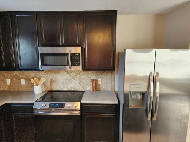 a kitchen with a refrigerator and a sink