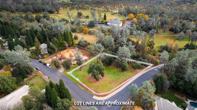 an aerial view of swimming pool with a yard and outdoor seating