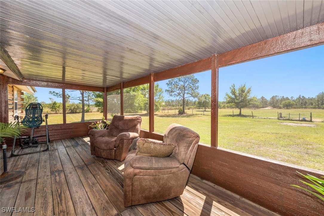 47350 Bermont Road Punta Gorda, FL 33982 - Photo 12 of 41 a living room with furniture and floor to ceiling windows