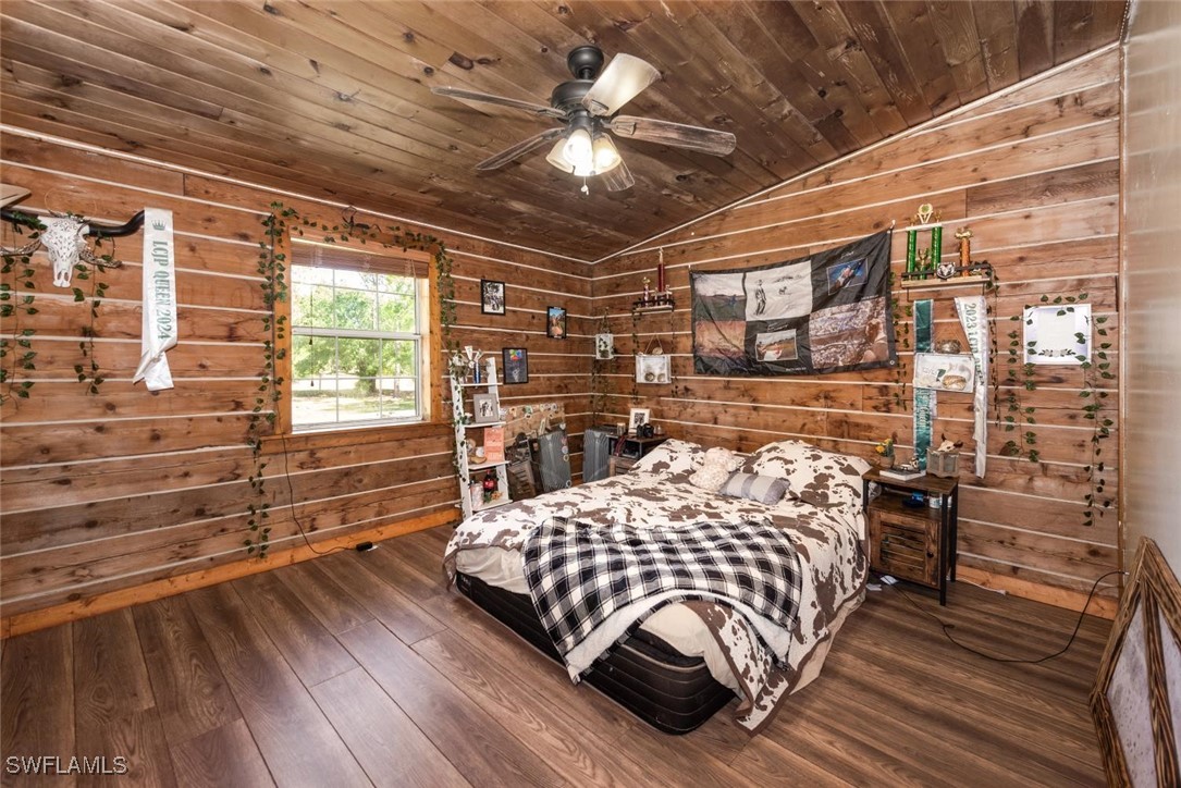 47350 Bermont Road Punta Gorda, FL 33982 - Photo 16 of 41 a bedroom with a bed and wooden floor