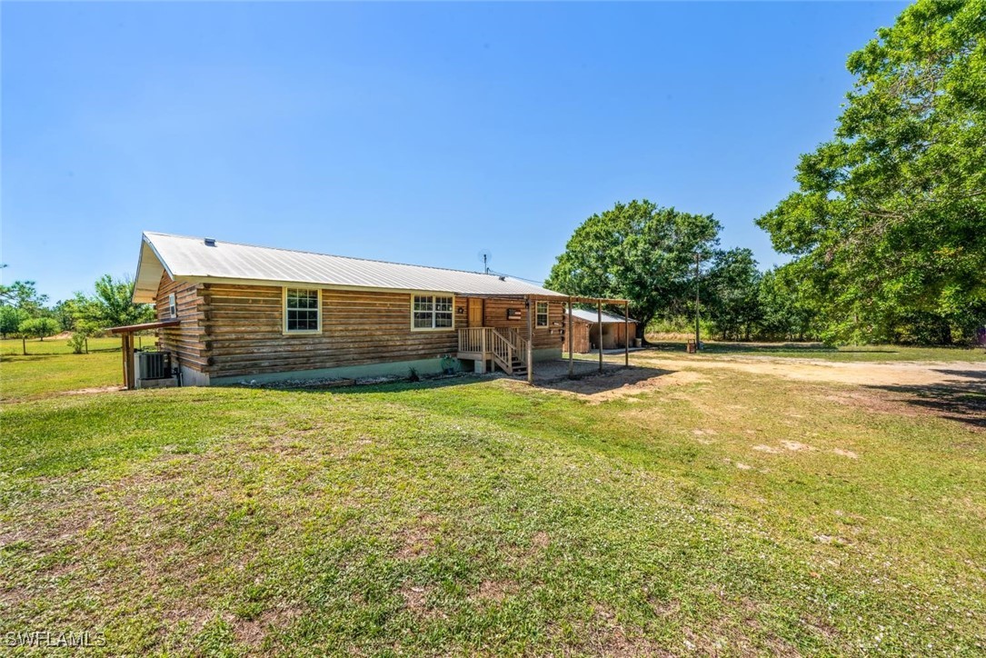 47350 Bermont Road Punta Gorda, FL 33982 - Photo 33 of 41 a backyard of a house with lots of green space