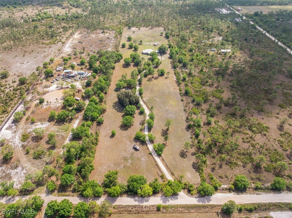 47350 Bermont Road Punta Gorda, FL 33982 - Photo 4 of 41 a aerial view of a house with a yard and large trees