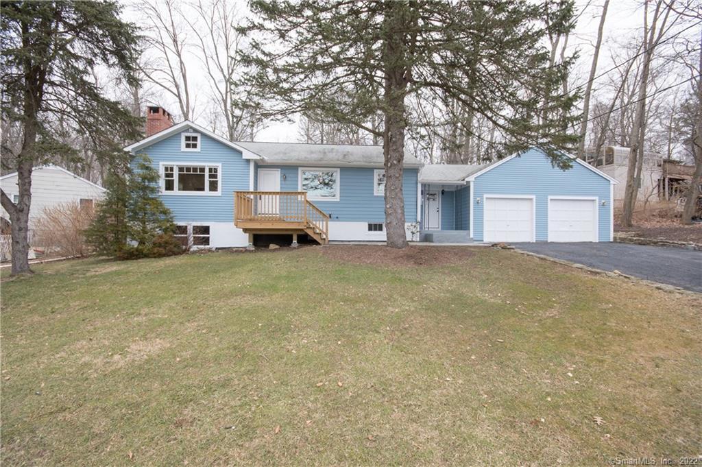 472 Bennetts Farm Road Ridgefield, CT 06877 - Photo 1 of 1 a front view of a house with a yard and trees