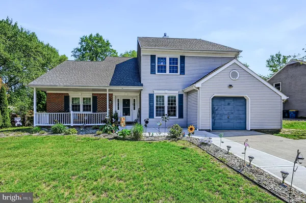 a front view of a house with a garden and porch