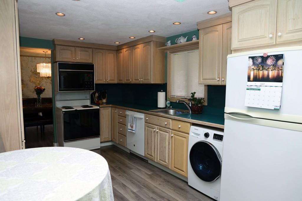 14 Catherine Road Framingham, MA 01701 - Photo 12 of 24 a kitchen with a refrigerator and a stove top oven
