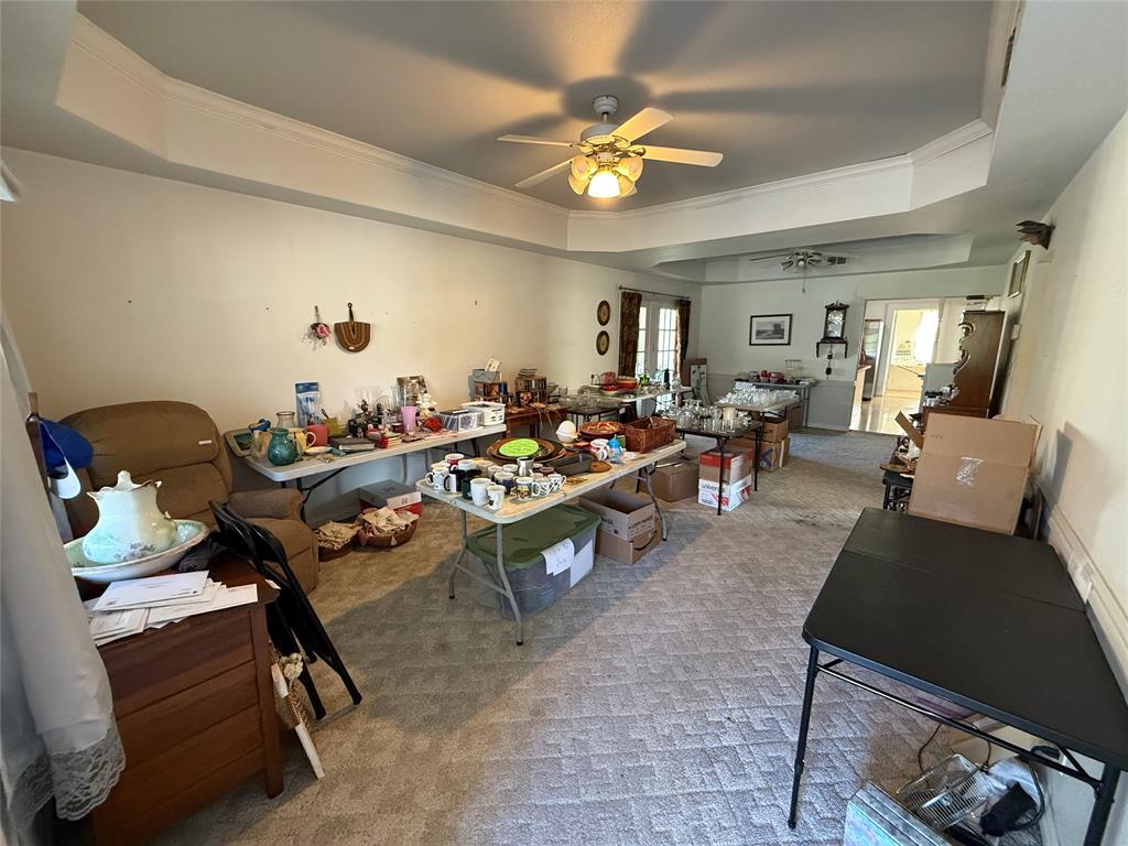 507 South Jackson Street Kaufman, TX 75142 - Photo 5 of 16 a living room with furniture and a chandelier