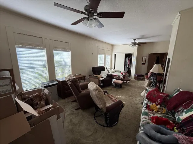 a living room with furniture gym equipment and a large window