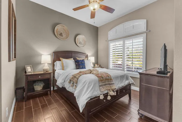 a view of a dining room and livingroom with furniture wooden floor a chandelier