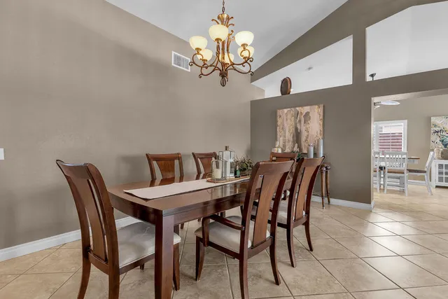 a living room with furniture a fireplace a large window and a fireplace