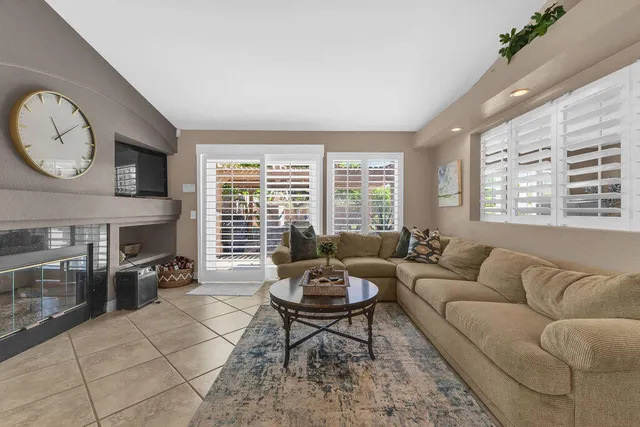 a kitchen with stainless steel appliances granite countertop a stove a sink dishwasher a dining table and chairs with wooden floor