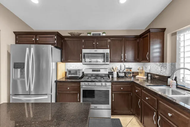 an aerial view of a house with a yard and garden