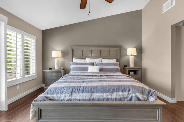 a bedroom with a bed and wooden floor