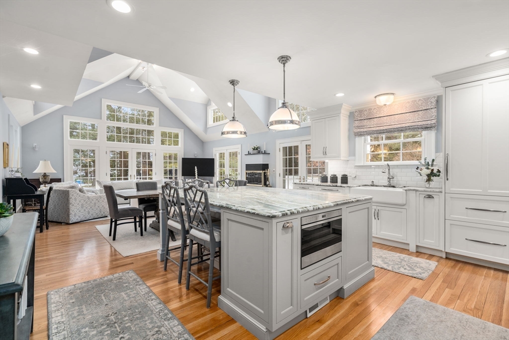 135 Glen Road Wellesley, MA 02481 - Photo 5 of 33 a kitchen with stainless steel appliances granite countertop a stove a sink dishwasher and a dining table with the kitchen view