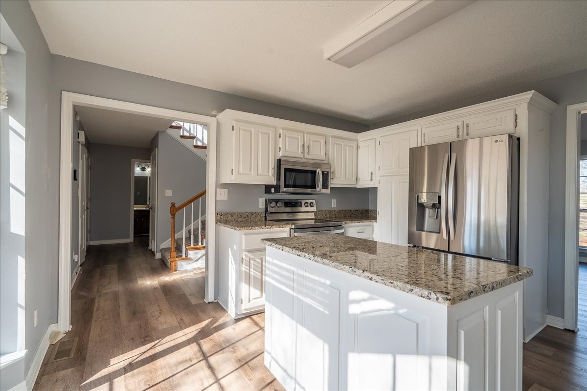 1126 Crowder Road Lawrenceburg, TN 38464 - Photo 15 of 50 a kitchen with stainless steel appliances granite countertop a refrigerator a stove and a sink