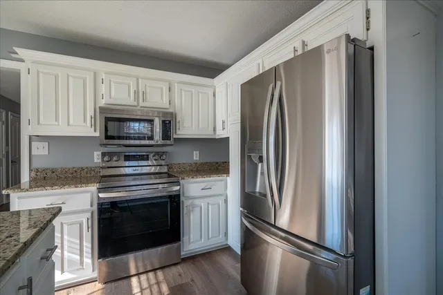 a kitchen with stainless steel appliances granite countertop a stove and a granite counter tops