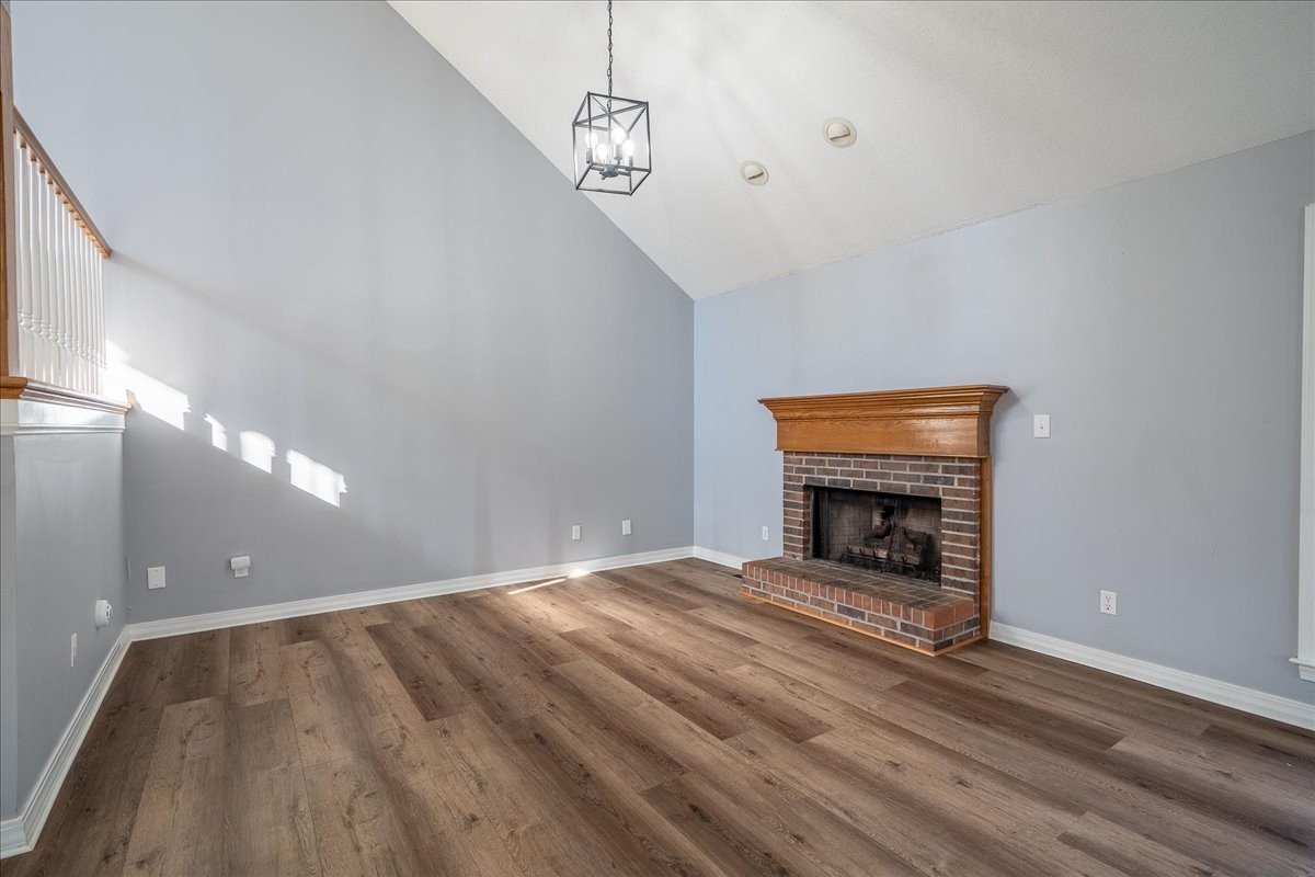 1126 Crowder Road Lawrenceburg, TN 38464 - Photo 21 of 50 a view of an empty room with wooden floor fireplace and a window