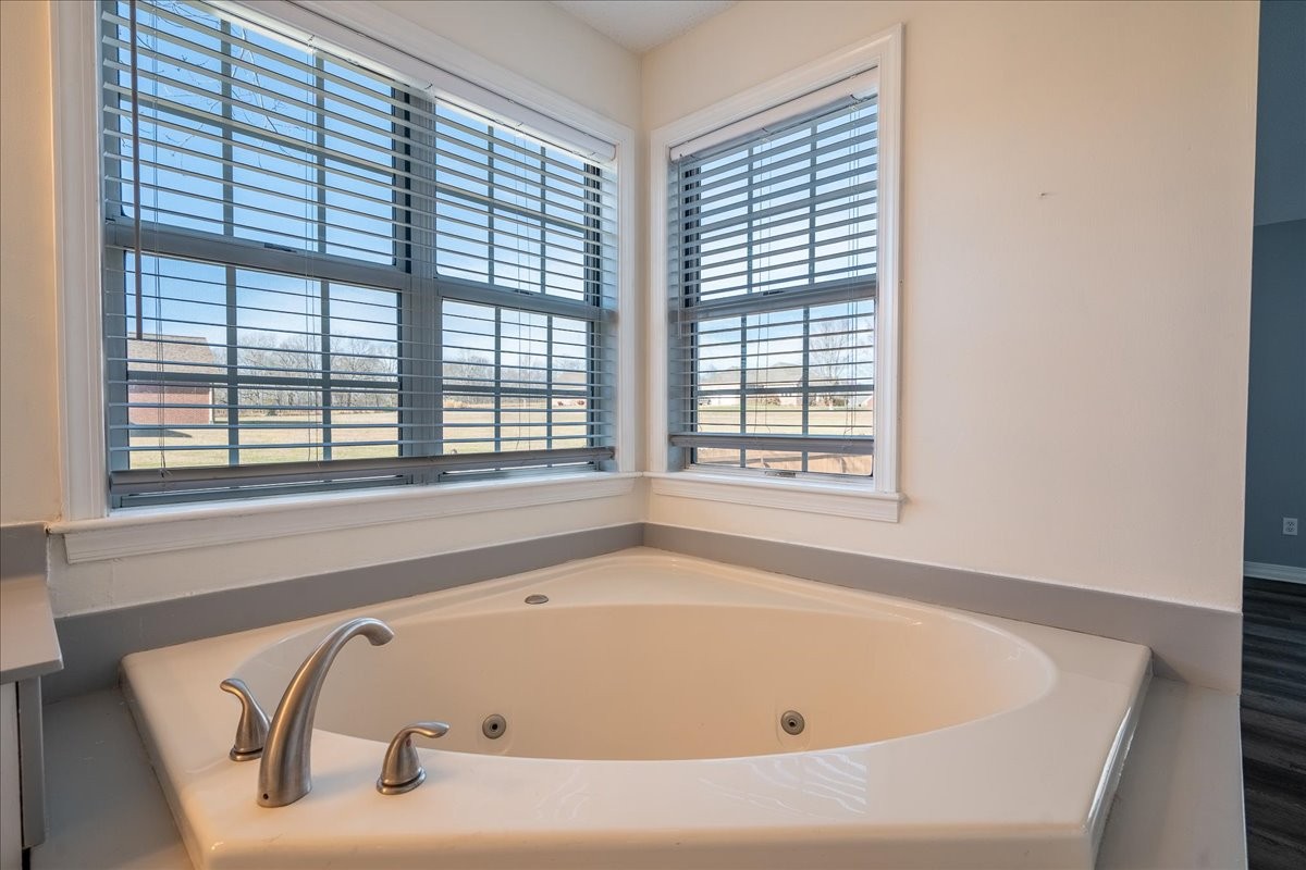 1126 Crowder Road Lawrenceburg, TN 38464 - Photo 32 of 50 a white bath tub sitting in a bathroom next to a window