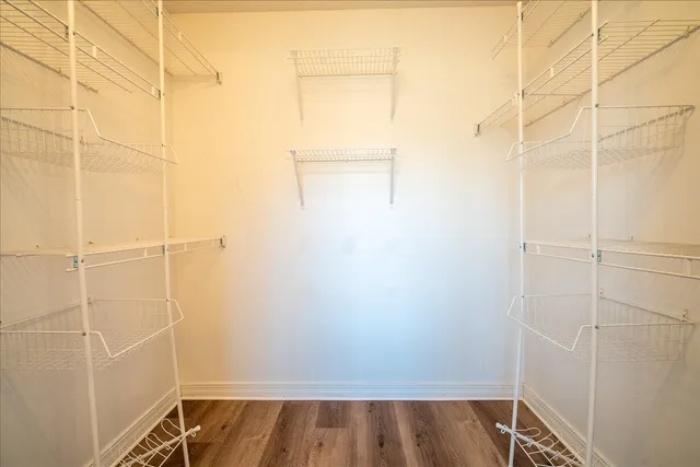 a view of a room with wooden floor