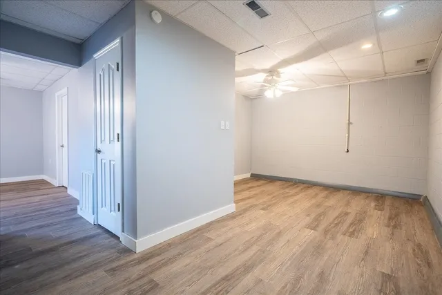 a view of an empty room with wooden floor