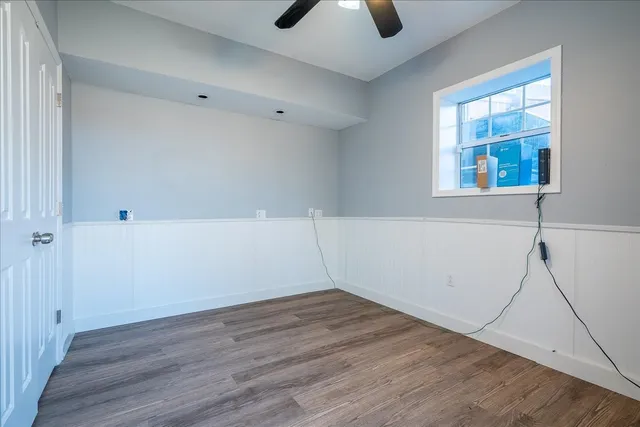 wooden floor in an empty room with a window