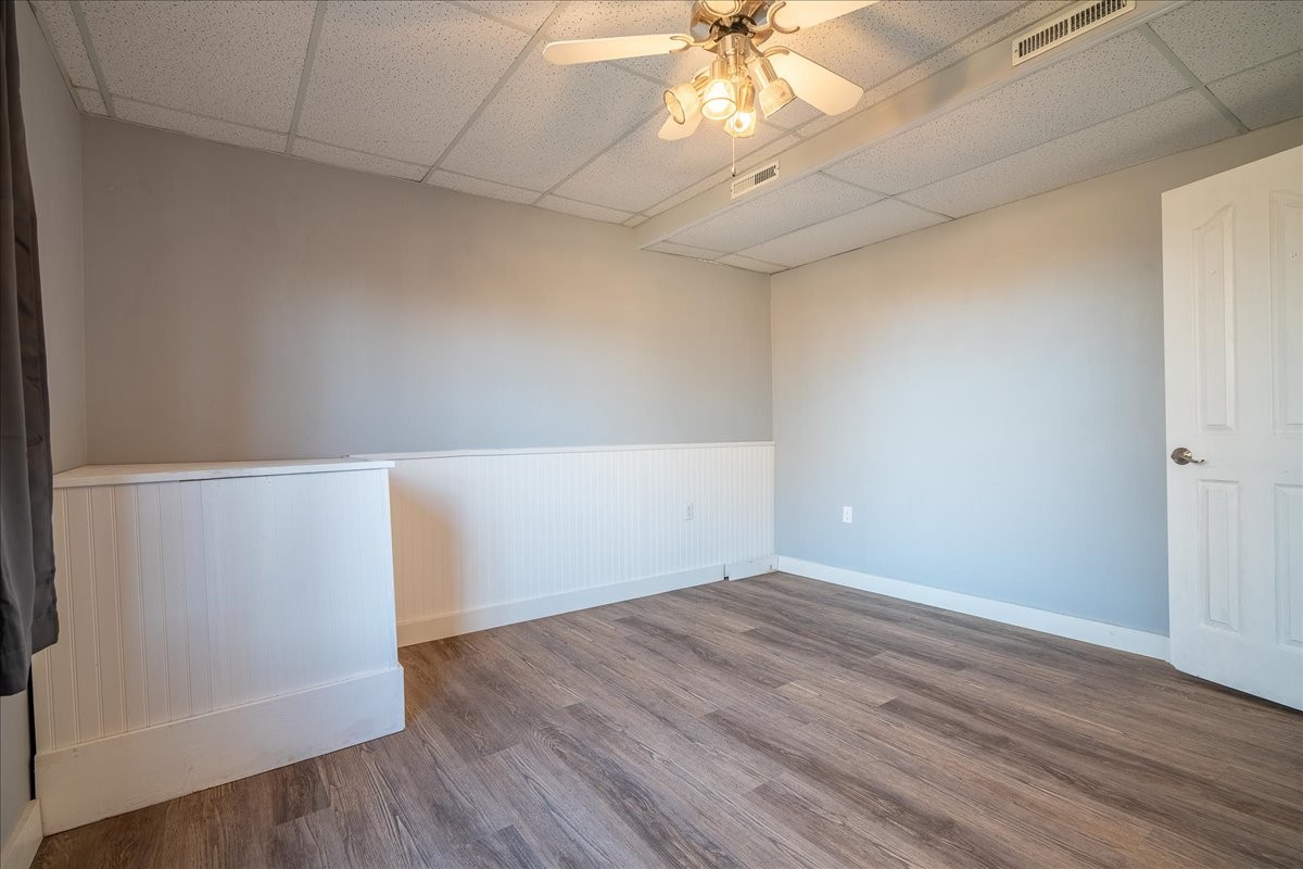 1126 Crowder Road Lawrenceburg, TN 38464 - Photo 48 of 50 an empty room with wooden floor and chandelier fan