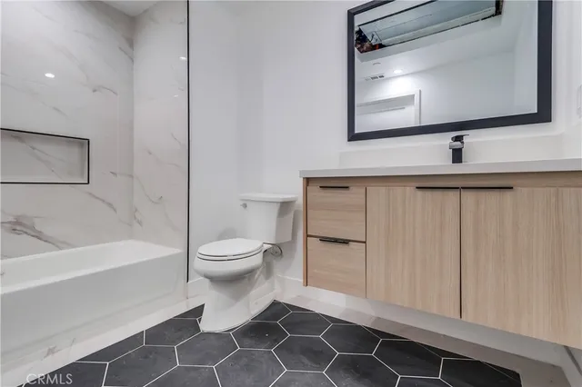 a bathroom with a toilet a sink and bathtub