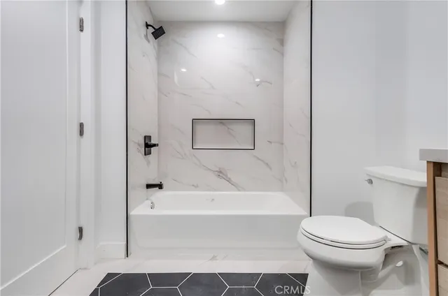 a bathroom with a toilet and a bathtub