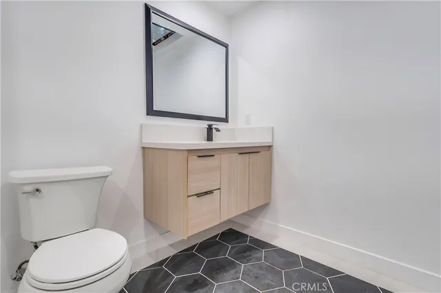 a bathroom with a toilet a sink and mirror