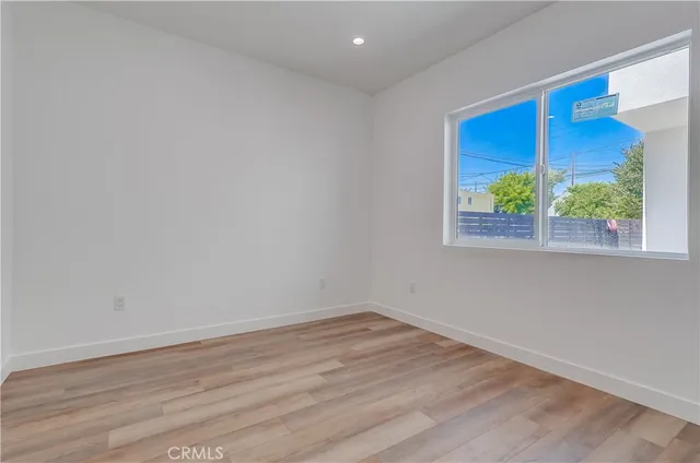 a view of a room with wooden floor and a window